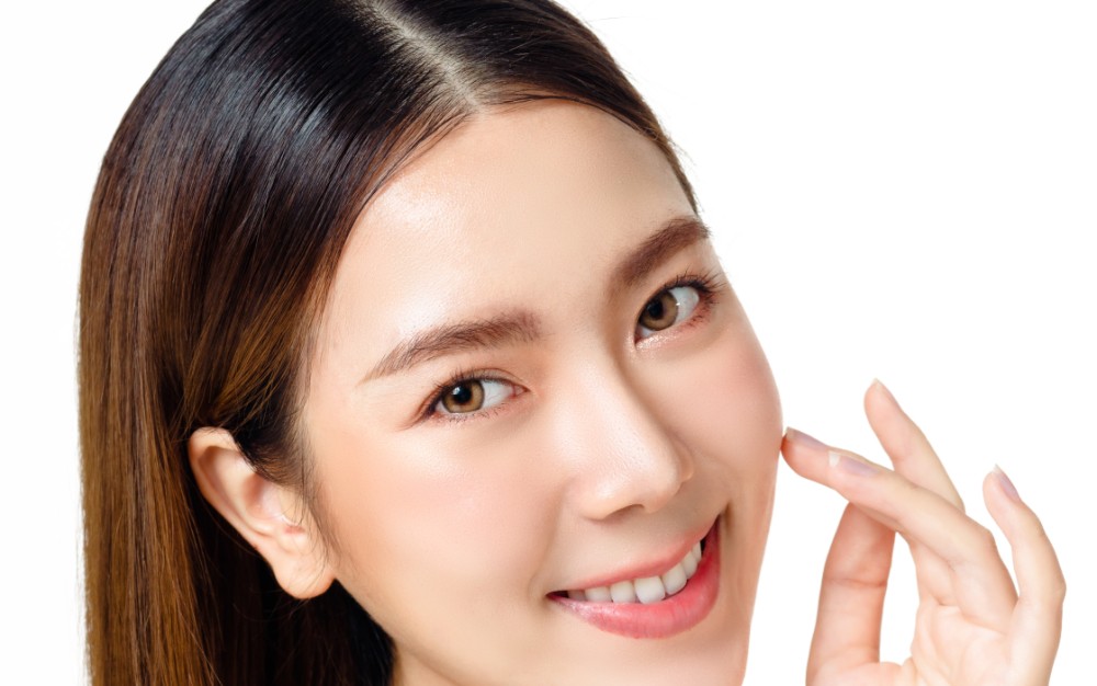 Asian woman with a beautiful face and fresh, smooth skin is dres