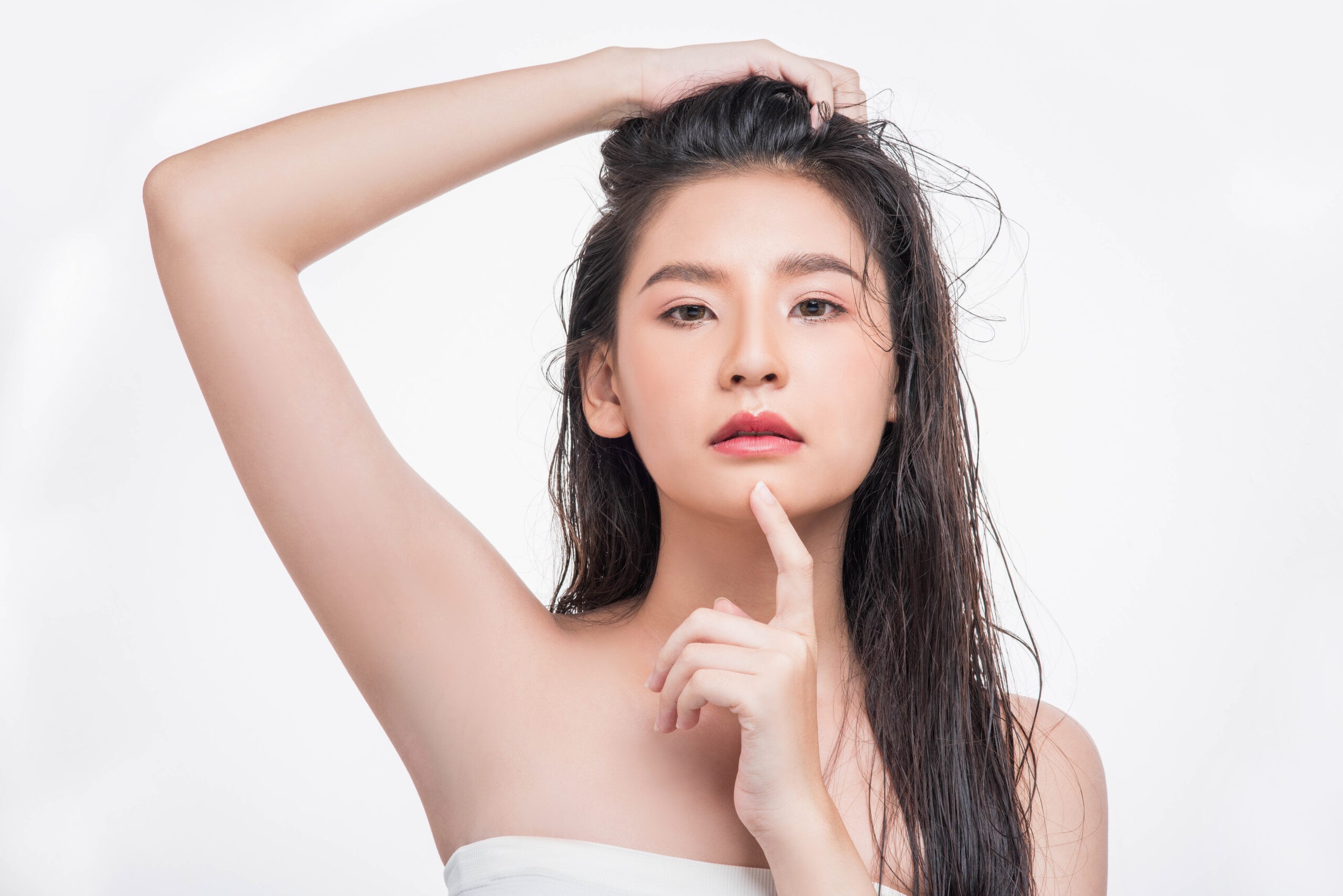 A beautiful, beautiful woman catches her messy hair.