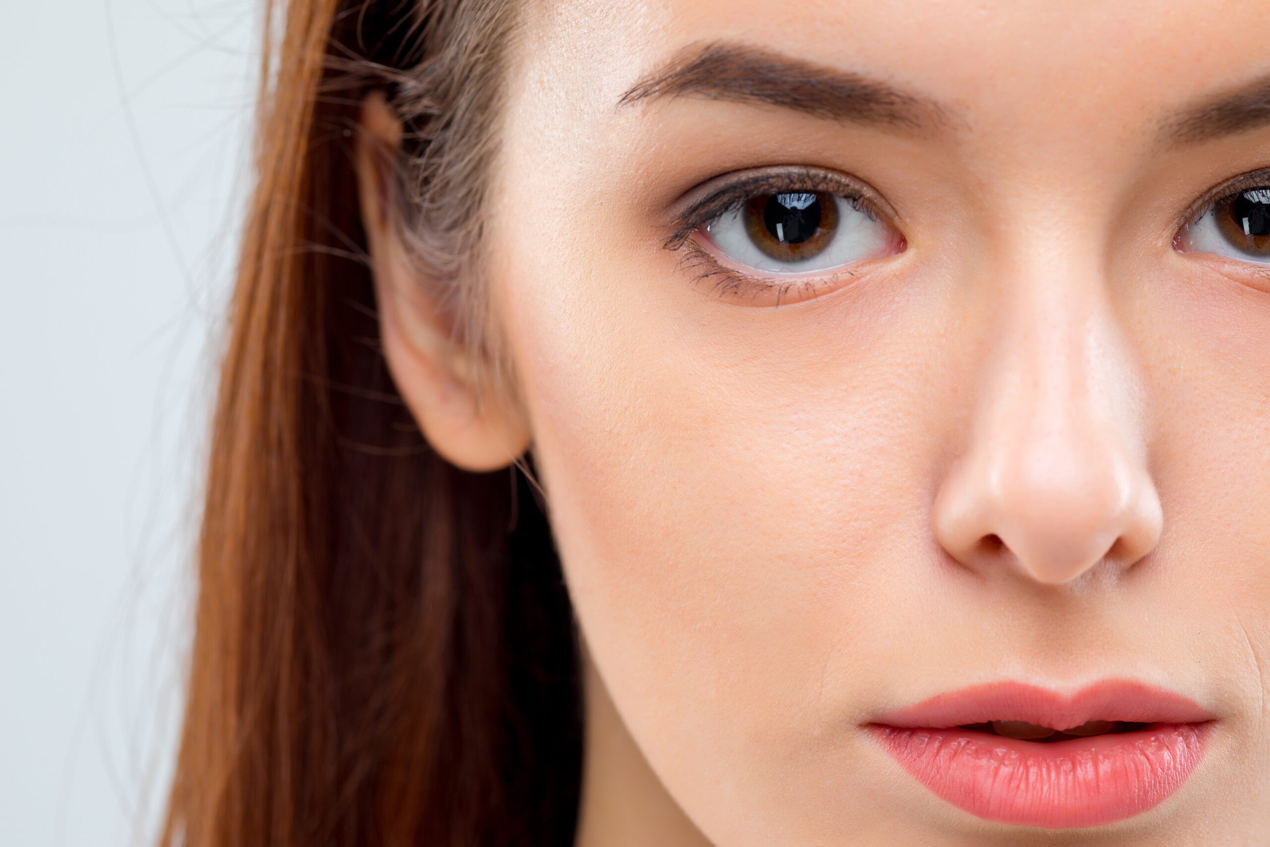 The face of woman on gray background